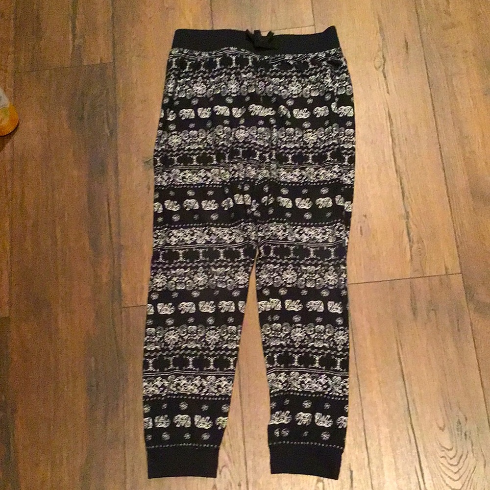 B&W sweatpants with elephants and flowers all along the legs of the pants